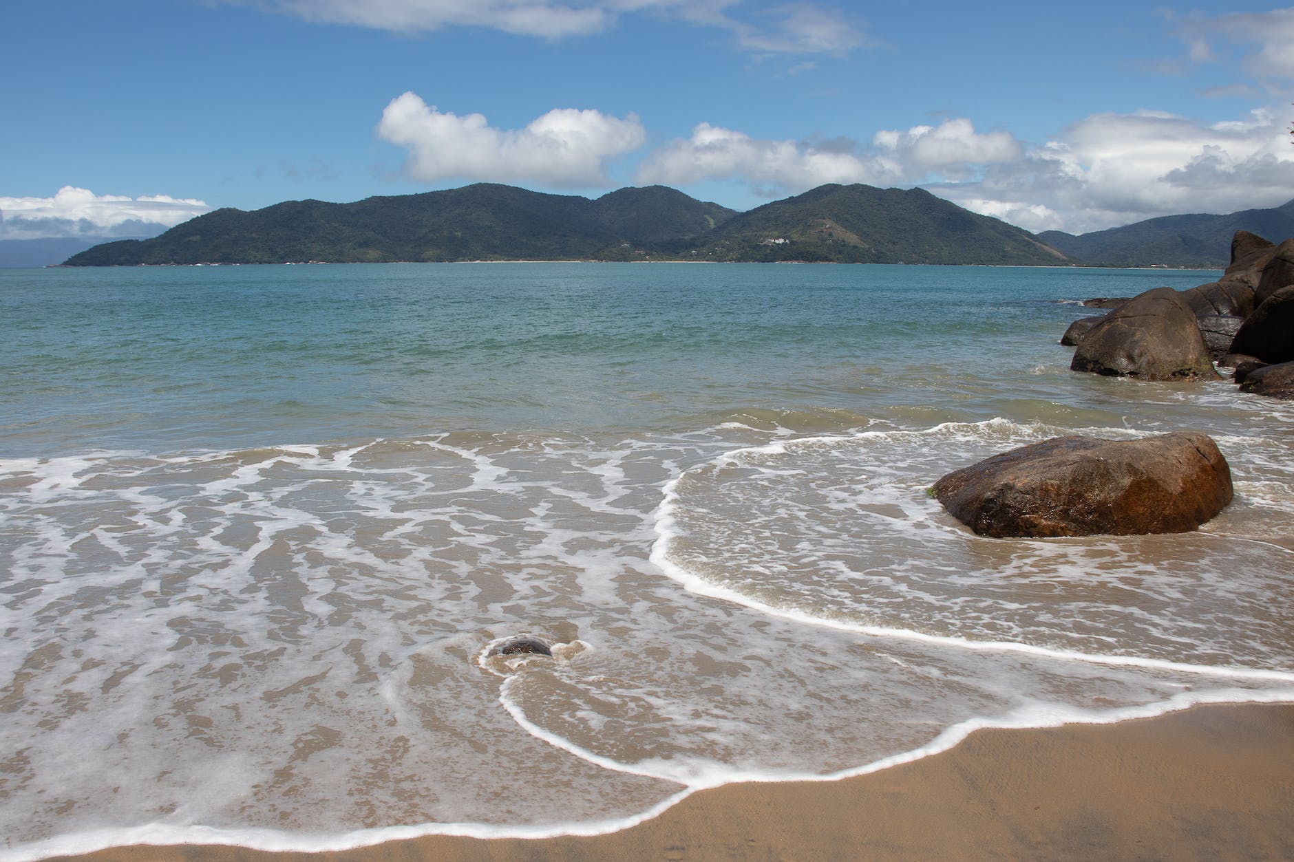 beach with an island in the background