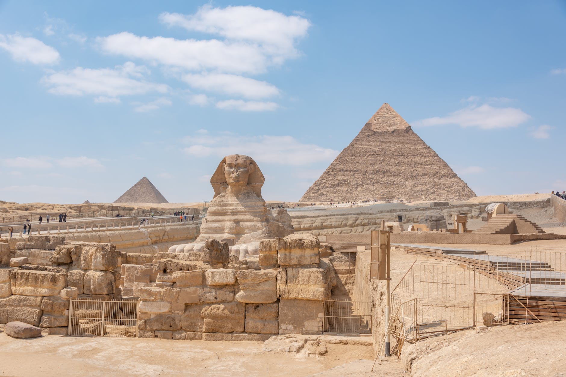 pyramids and sphinx statue in desert