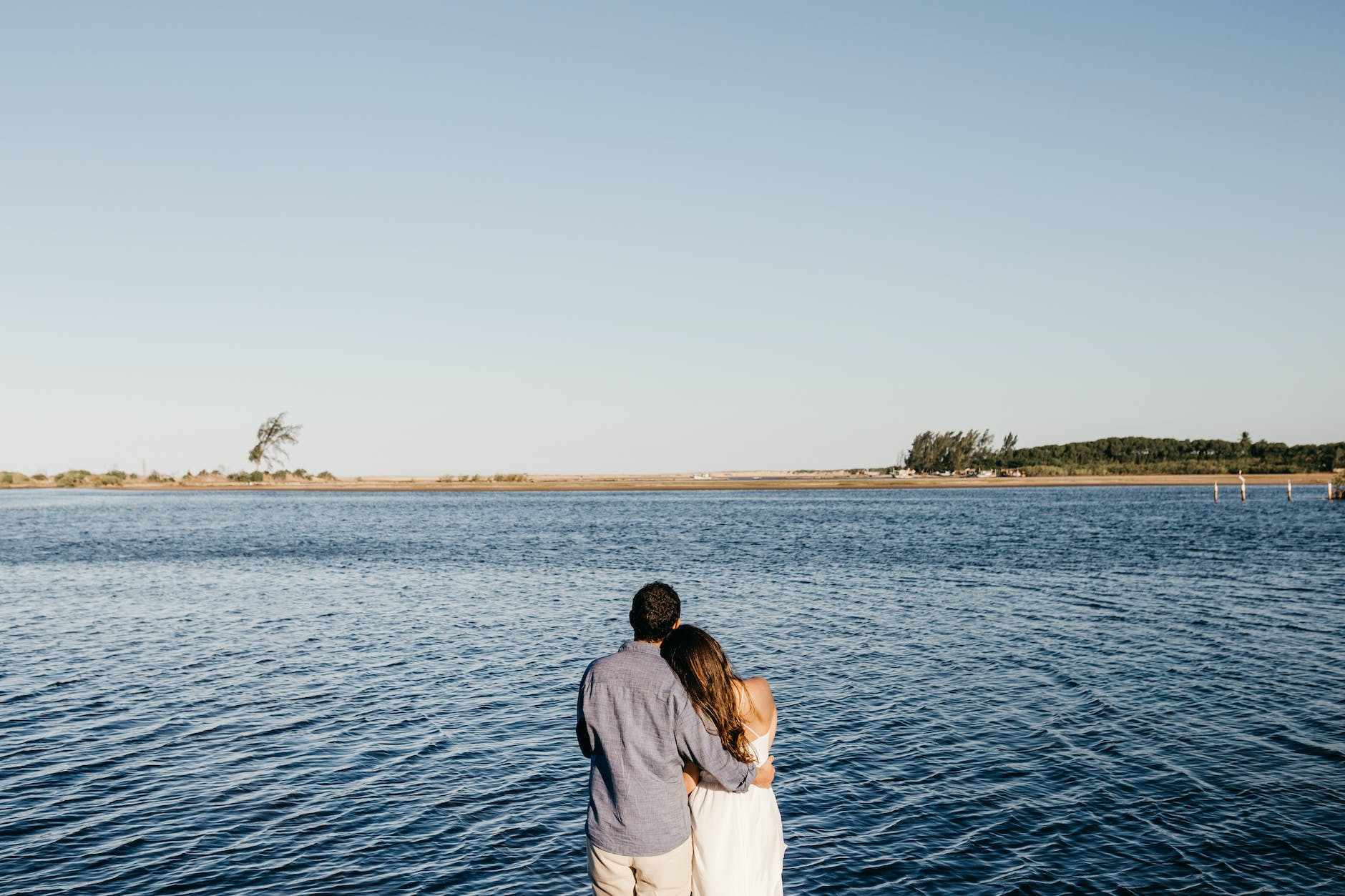 happy couple showing affection on beach